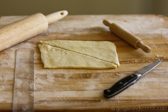 Cutting the croissant pastry dough Cutting the croissant pastry dough